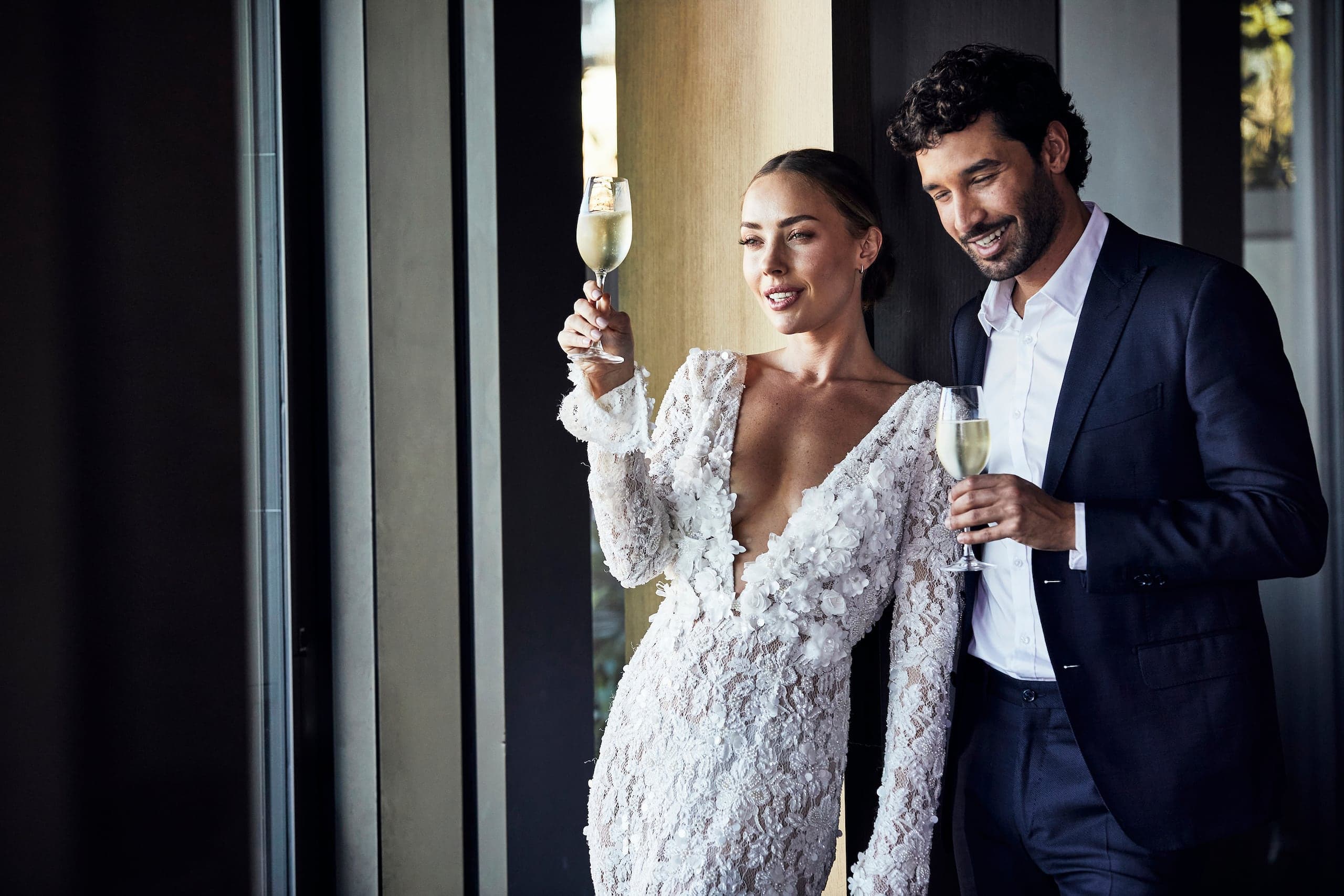 1 of 1 Wedding couple in love drinking champagne at the Hyatt Regency Dusseldorf and enjoying the view
